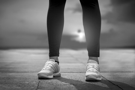 Runner feet running on road closeup on shoe. Woman fitness.の写真素材