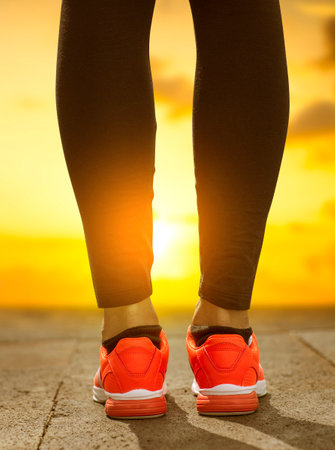 Runner feet running on road closeup on shoe. Woman fitness.の写真素材