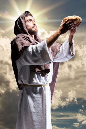 Jesus Christ praying to God in the dark black nightの写真素材