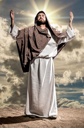 Jesus Christ praying to God in the dark black nightの写真素材
