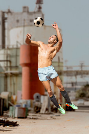 soccer player playing street soccer by dayの写真素材