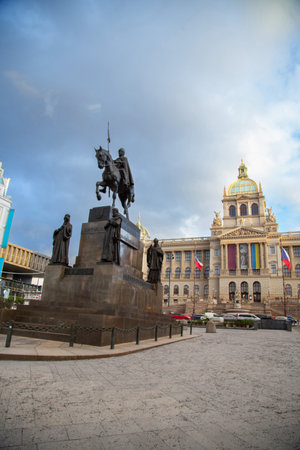 Statue of St. Wenceslas on horseback in the square in front of the front facade of the historic and famous museum in Prague during a beautiful cloudy afternoonの写真素材