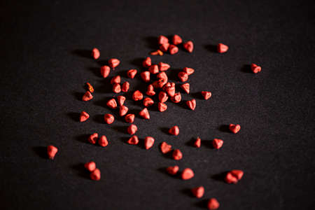 achiote on black background