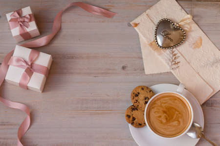 Amazing morning on Valentine's day with a cup of favorite coffee, gifts and letter from your beloved.の写真素材