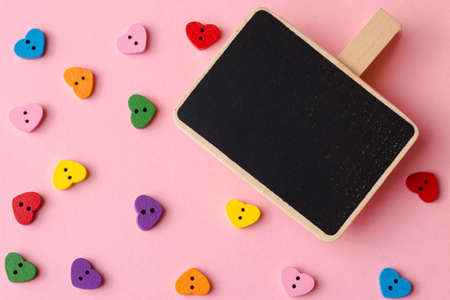 Heart-shaped buttons with a blackboard copy space. Valentine's day background close up.の写真素材