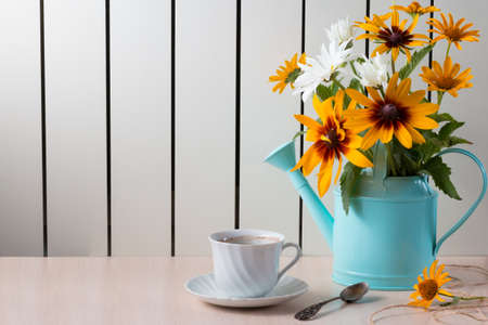 Bouquet of summer flowers like heliopsis, chamomile, rudbeckia and gaillardia in watering can.の写真素材
