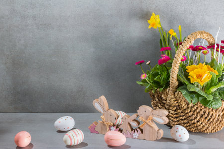 Easter eggs with spring flowers in a wicker basket.の写真素材