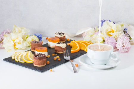Mini dessert with a cup of coffee with milk. sweets snacks.の写真素材