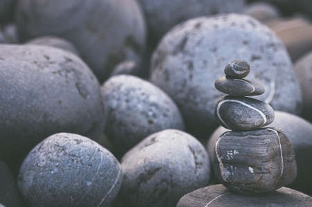 A four gray stone tower at a rocky beach.の写真素材