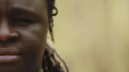 Half face of an african crying black man with a tear in the eye. High quality photo