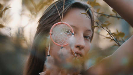 Hippie woman looking through dreamcatcher.の写真素材