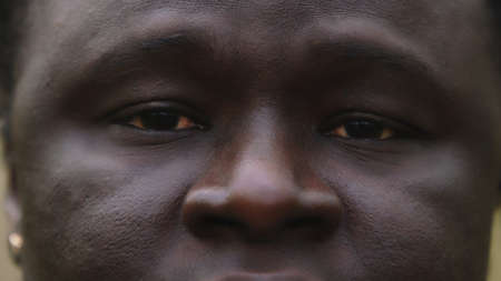 Black lives matter. Close up shot of african man with sad red eyes with tears. High quality photoの写真素材