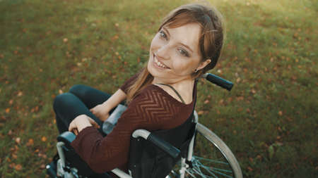 Beautiful disabled caucasian woman looking over the shoulder in the park. High quality photo