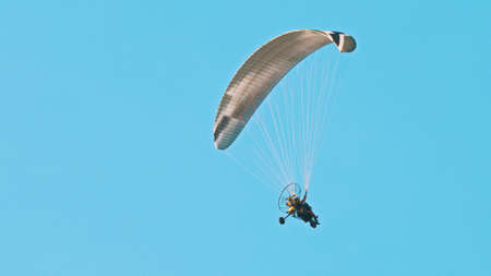 Paramotor Tandem Gliding And Flying In The Air. Copy space. High quality photoの写真素材
