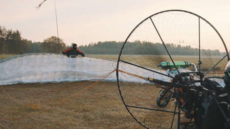 Paramotorgliding. Successfully landed, glider untying parachutist. High quality photoの写真素材