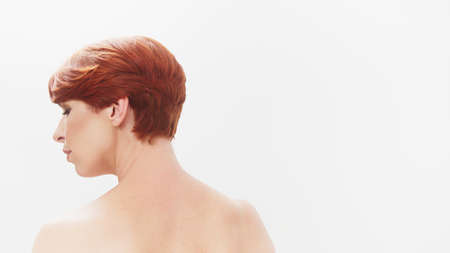 Beauty shot. Portrait of redhead nude woman isolated on white. Rear view. High quality photoの写真素材