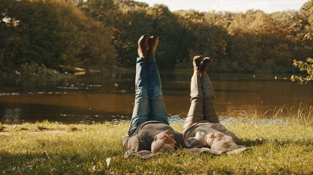 Wellbeing concept. Portrait of happy senior retired couple meditating in autumn park. High quality...