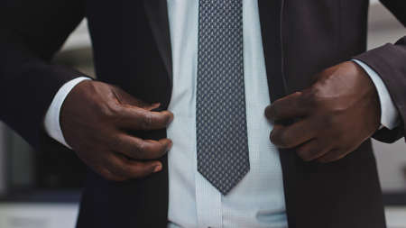 Stylish African Man in a Suit Buttoning the Jacket. High quality photoの写真素材