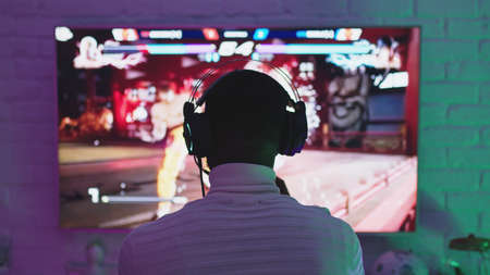 Warsaw, Poland 19.10.2020 Black man playing game using video game console controlling joystick. High quality photoのeditorial素材