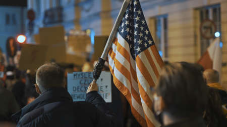 Warsaw, Poland 30.10.2020 - Anti abortion and human rights protest, Womens strike,. Man holding USA...