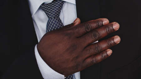 African american black businessman holding hand on his chest. High quality photo