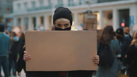 Protest and demonstrations. rebellious woman with face mask striking . High quality photoの写真素材