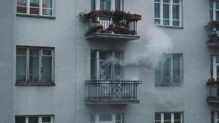 Smoke coming out of the appartment on fire. accident and disaster concept. High quality photoの写真素材