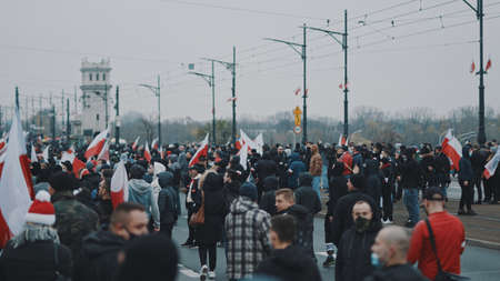 Warsaw, Poland 11.11.2020 - Crowd of people marching on the streets on 102nd anniversary of polish independece day. High quality photoのeditorial素材