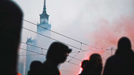 Warsaw, Poland 11.11.2020 - Independence day march on 102nd anniversary in Warsaw. People marching in the red smoke. High quality photoのeditorial素材