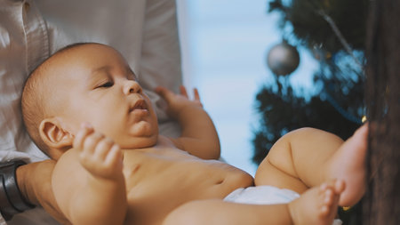 Happy family concept. Young african american black father holding his mulatto baby. High quality...