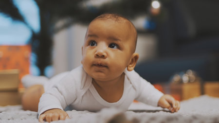 Adorable african american black baby enjoying tummy time. High quality photoの写真素材