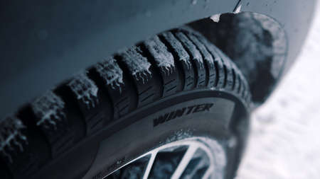 Close up, winter car tires covered in snow. High quality photo