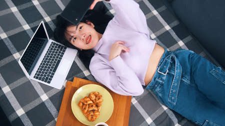 Young influencer posting pictures of her breakfast on social media.