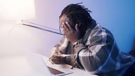 Unwell man with high fever seeking help from docor remotely. High quality photoの写真素材