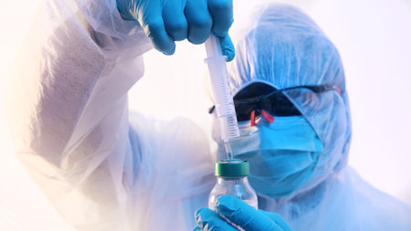 Vaccination and immunization against . Doctor in full uniform preparing vaccine. High quality photo
