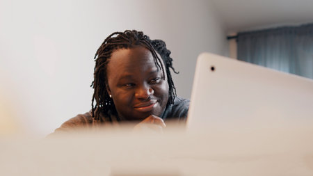 Young african man smiling and nodding the head while having video call. Online dating concept. High...