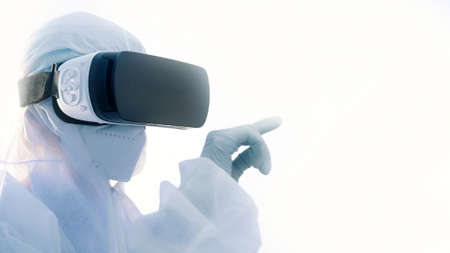 Virologist in full protective suit using vr glasses in research. High quality photoの写真素材