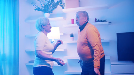 Happy elderly retired couple dancing at home. Birthday, valentines day or anniversary concept. High quality photoの写真素材