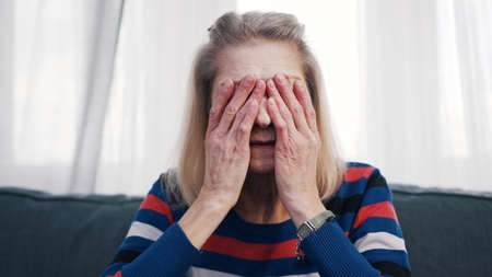 Elderly woman suffering from headache. High quality photoの写真素材