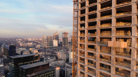 Warsaw, Poland 03.16.2020 Elevated view of tall building construction progress lit by evening sun....