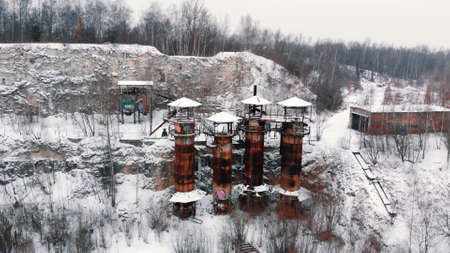 Winter view of old rusty machinery and piping equipment in closed limestone Liban quarry Kamieniolom Liban in Krakow, Poland.の写真素材