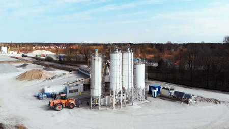 Warsaw, Poland 04.10.2019 - Construction machinery for mixing concrete to highway. Aerial view from drone on road construction site near Warsaw, Poland.のeditorial素材