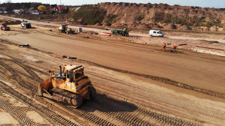 Warsaw, Poland 04.10.2019 - Lively traffic of machinery. Aerial view from drone on road construction site near Warsaw, Poland.のeditorial素材
