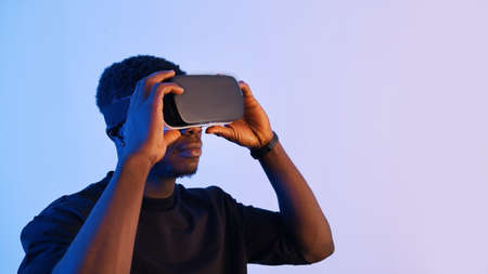 Man wearing Virtual Reality glasses enjoying the 360 Degree virtual environment. High quality photoの写真素材