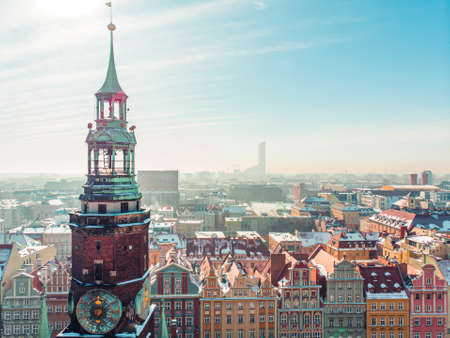 Wroclaw, Poland 14.02.2021 - Wroclaws Market Square (Rynek) closeup view. Panoramic view of the city against the blue sky with sun rays. Concept of the colorful city with old architecture.のeditorial素材