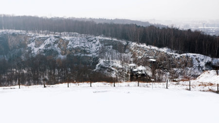Liban Quarry - A historic site where prisoners were kept during Second World War. Old machines and piping equipment. Light snow-fall. High quality photoのeditorial素材