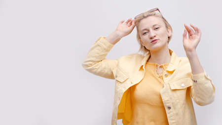 Cute girl wearing sunglasses on her head. Isolated girl over white background studio. The girl is...