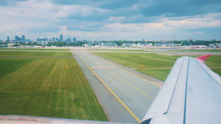 A passenger airplane taxiing runway after landing at the airport. Wing of a flying airplane landing...