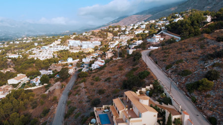 Altea Hills, Spain 18.08.2021 - Beautiful holiday villas at Altea Hills. Aerial shot of Pueblo Mascarat, Alicante, Costa Blanca, Valenciana province. The shot is taken during the daytime.のeditorial素材