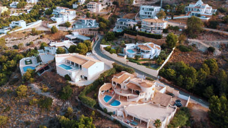 Altea Hills, Spain 18.08.2021 - Beautiful holiday villas at Altea Hills. Aerial shot of Pueblo Mascarat, Alicante, Costa Blanca, Valenciana province. The shot is taken during the daytime.のeditorial素材